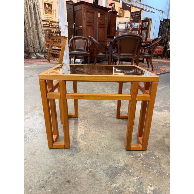 This mid-century modern coffee table blends a heavy, architectural presence with clean geometric lines. The base is...