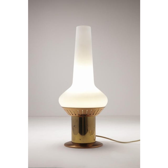 Table lamp with satin opaline glass diffuser and brass structure. Manufacturer's label on the base. Stilnovo Production...