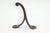 Vintage single arm black finished cast iron wall hook with a ball tip. The original mounting screws are not available....