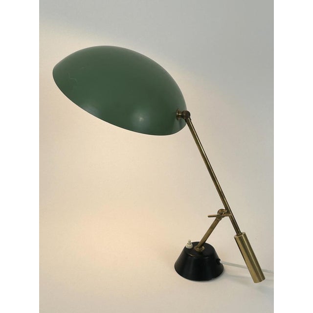 Rare, elegant and large mid-century modern table lamp or desk light. Adjustable height and lamp shade. Manufactured by bag...