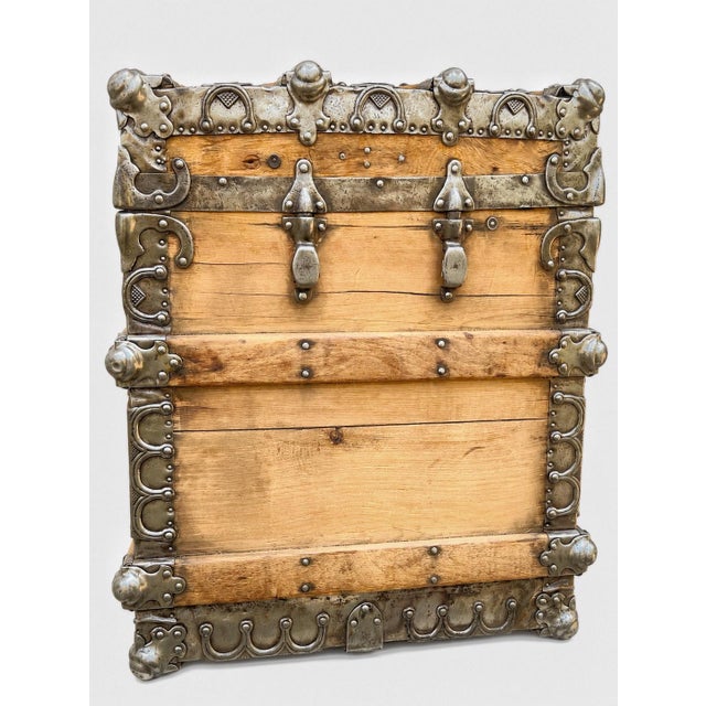 Extraordinary late 19th to early 20th century iron-clad steamer trunk featuring exceptionally ornate riveted metalwork,...