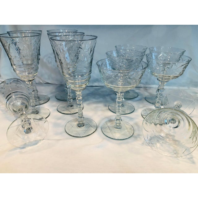 Elegant vintage crystal stemware set featuring delicately etched bowls and faceted stems. This coordinated set of twelve...