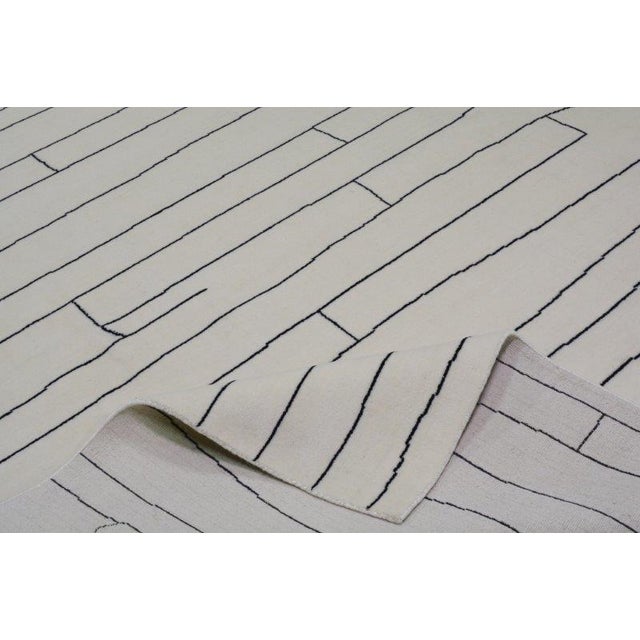 Moroccan Azilal hand knotted wool rug with abstract design.