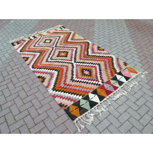 This beautiful, traditional vintage, flatweaved Turkish kilim rug is approximately 60 years old. It is handmade of very...