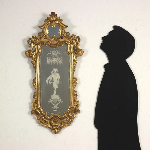 Group of four baroque mirrors carved with volutes and floral motifs, entirely gilded with leaves; the mercury mirrors (one...