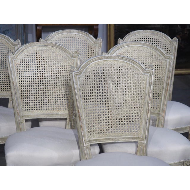 More information coming soon… Hand-carved and hand-painted in the early 1900s, this set of six caned chairs is in the...