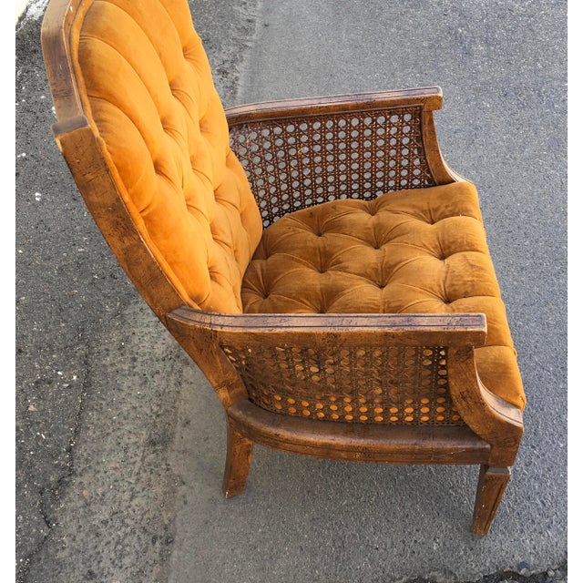 Hi, 1960s era mid century vintage caned tufted back and seat velvet or velour armchair. Orange material. Light wood...