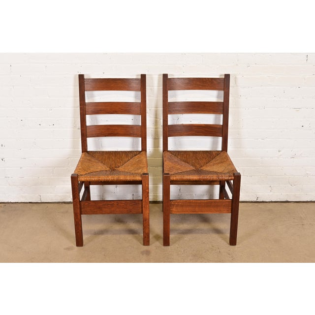 A rare and exceptional pair of Mission or Arts & Crafts period ladder back side chairs or dining chairs By Gustav Stickley...