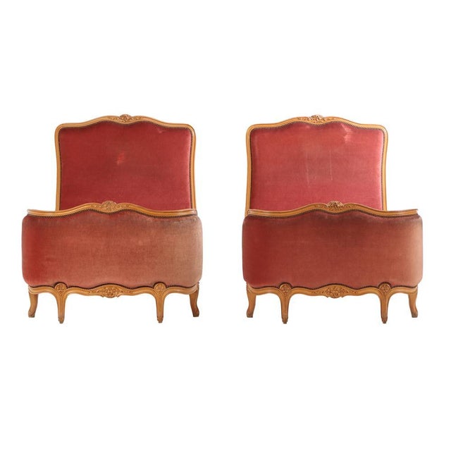 Each bed features finely carved wooden frames with characteristic rococo motifs—scrolls and floral detailing—reflecting...