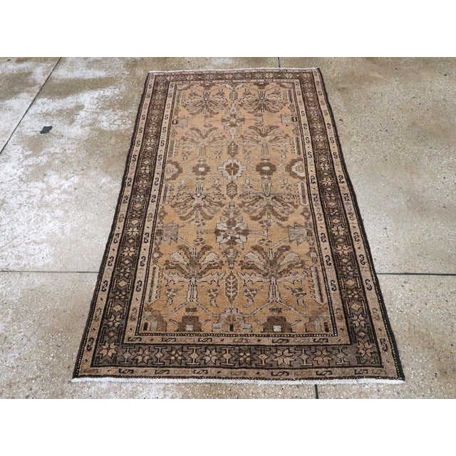 This mid-20th century Persian Malayer rug, measuring 3' 5" x 6' 0", presents a graceful allover design woven in a refined,...