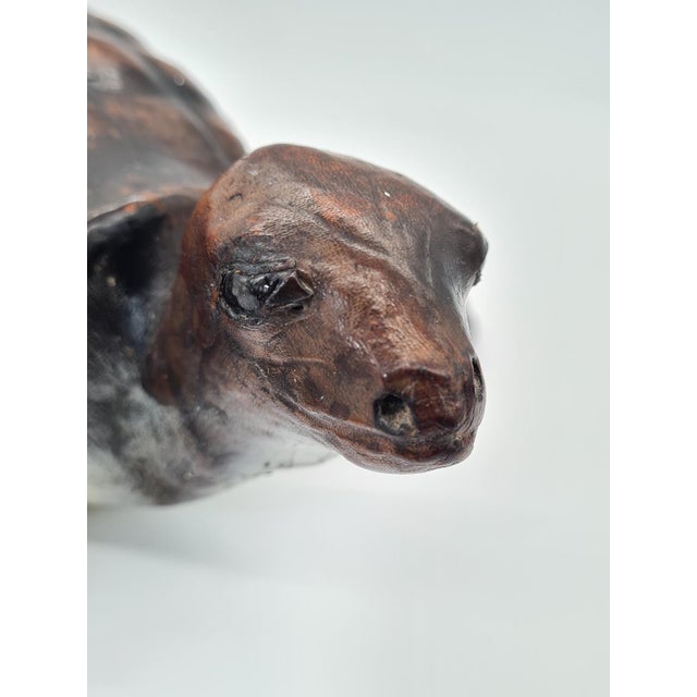 An original decorative figure depicting a turtle, made of natural leather molded onto a sculptural structure. The surface...
