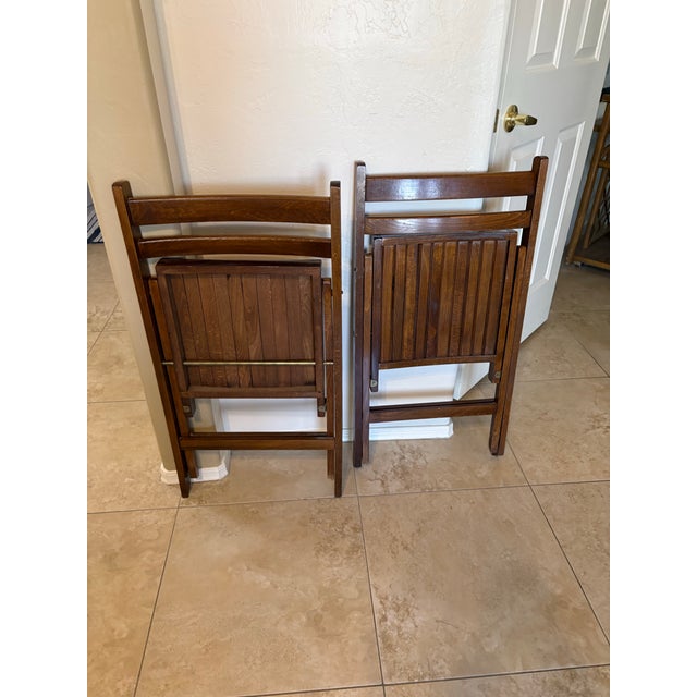 Vintage mid-century dark wood slat folding chairs (commonly known as Trieste-style folding chairs, often made in Romania...