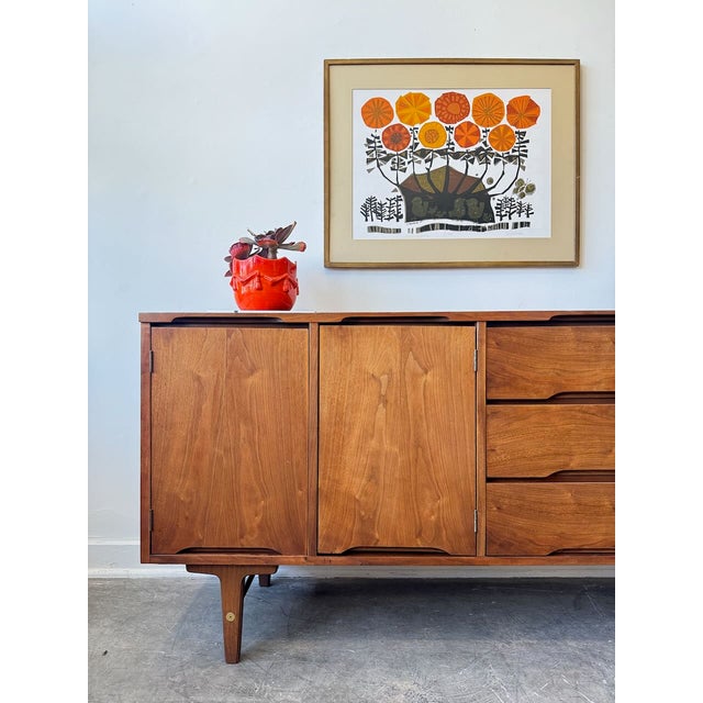 Beautifully restored vintage walnut credenza by Stanley Furniture, showcasing the clean lines and timeless simplicity that...