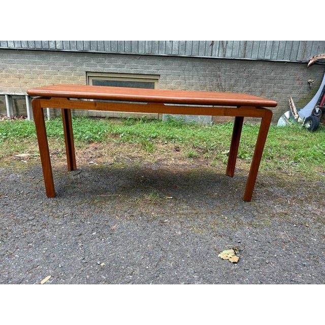 Danish Mid Century Teak Floating Top Design Low Console Table. it features a floating top, rich wood grain, sculpted round...