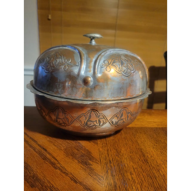 Gorgeous, hand crafted copper and tin bowl with lid. It has a scalloped trim and hammered finish as well as intricated...