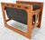 This is a very nice Danish Modern teak and dark brown leather magazine rack designed by Salin Møbler. The 1980s era...