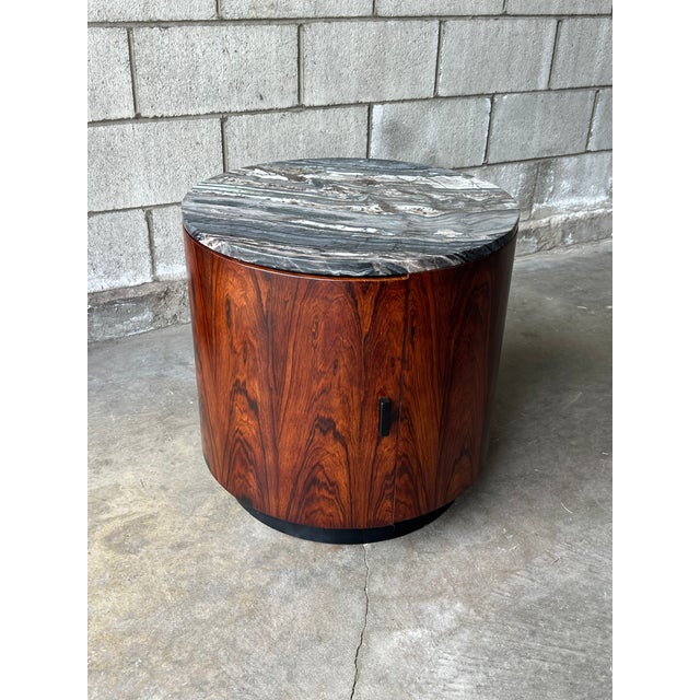Striking 1950s cylindrical drum table and compact bar cabinet in the manner of Harvey Probber, featuring richly figured...