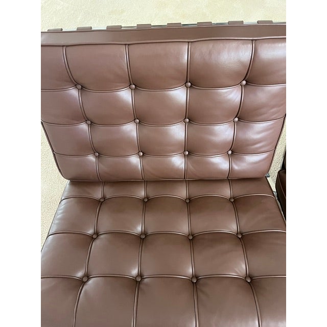 Authentic pair of KnollStudio Barcelona chairs designed by Ludwig Mies van der Rohe. Upholstered in brown leather with...