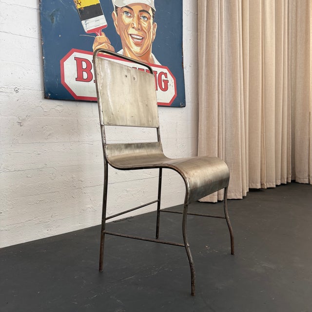 This striking early 20th century hospital side chair in it's simple form offers a primitive, industrial flair. The chair...