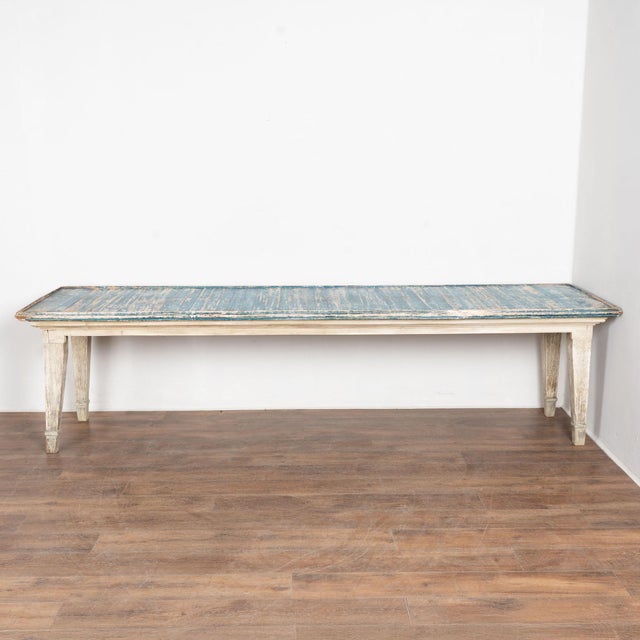 Early 20th century French 10' table, crafted in pine and retaining its original painted finish. The top is finished in...