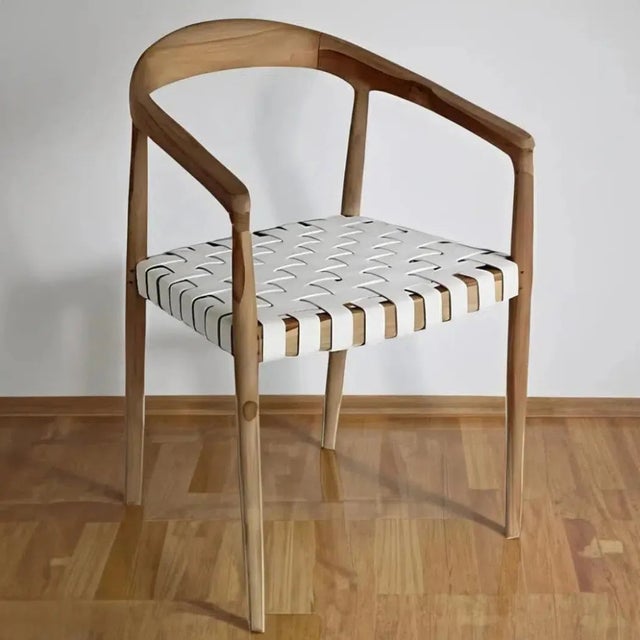 Indulge in the perfect blend of luxury and functionality with the Eijnar White Leather Dining Chair by Artesia....