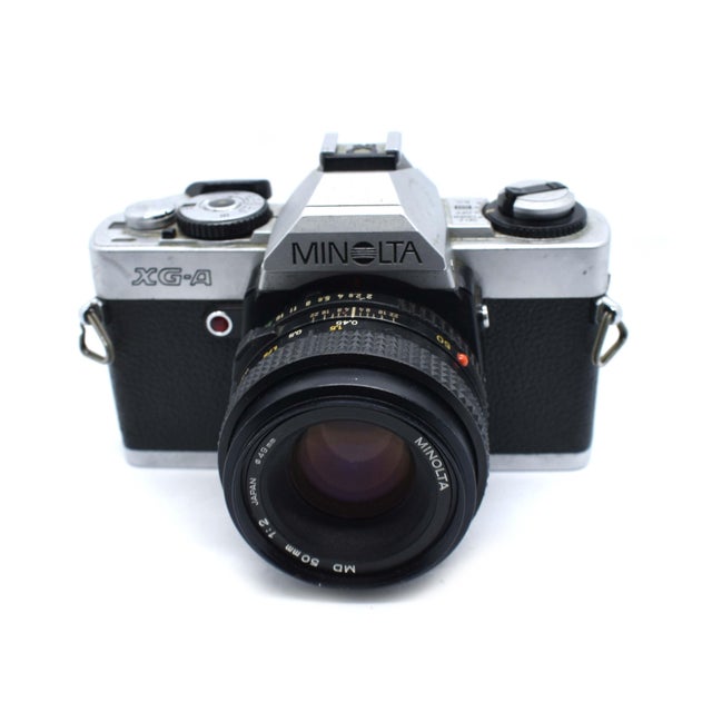 Elevate your shelving, desktop, or studio with this striking Minolta XG-A, a definitive piece of early 1980s Japanese...