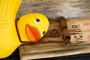 Spring by Josh Talbott | Acrylic on Canvas Yellow rubber duck on a wooden surface with a trap.