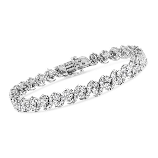Glamorous yet timeless, this beautiful tennis bracelet has a unique pattern of alternating studded silver "s" links and...