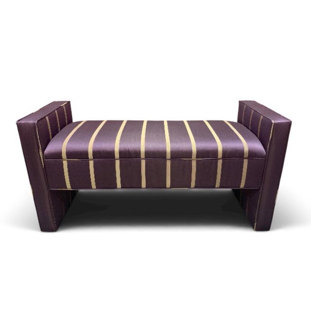A vintage Art Deco upholstered bench featuring vertical striped fabric and high armrests. Originating in France during the...