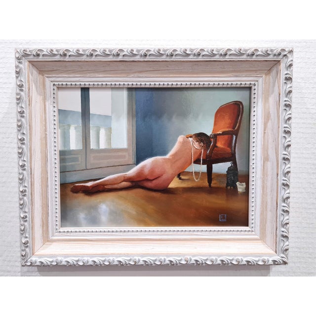 This oil on panel artwork presents a serene and intimate scene, featuring a reclining figure draped over a chair,...