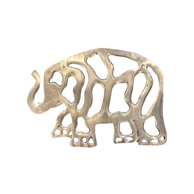 A lovely, pair of vintage brass trivets. Each features an elephant firm trivet in solid brass. Unmarked. Circa 1970.