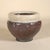 A striking vintage studio pottery vessel featuring a richly atmospheric raku-fired surface. The form is finished in a warm...