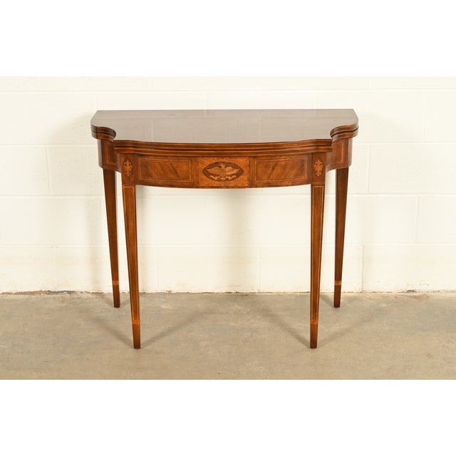 A gorgeous Federal or Hepplewhite style flip-top console or game table By Baker Furniture USA, Circa 1980s Mahogany, with...