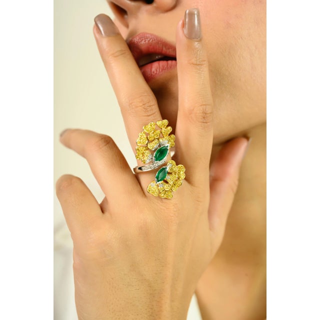 Elevate your style with this exquisite floral-inspired cocktail ring, crafted in 14k yellow gold. Featuring two vivid...
