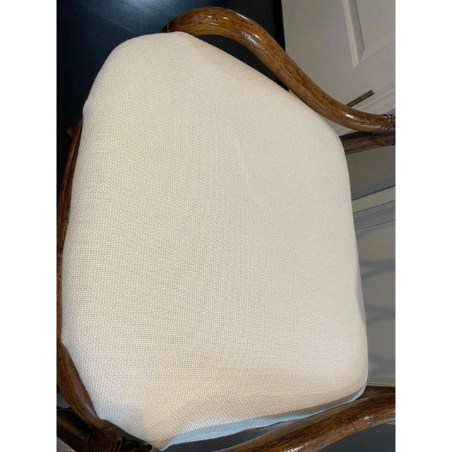 Offered is a vintage bamboo accent chair by Henredon. This chair features a warm brown bamboo frame and an upholstered...