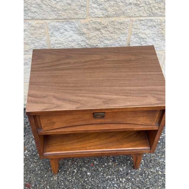 Mid-Century nightstand featuring a single upper drawer with original metal pull and a lower open storage shelf.