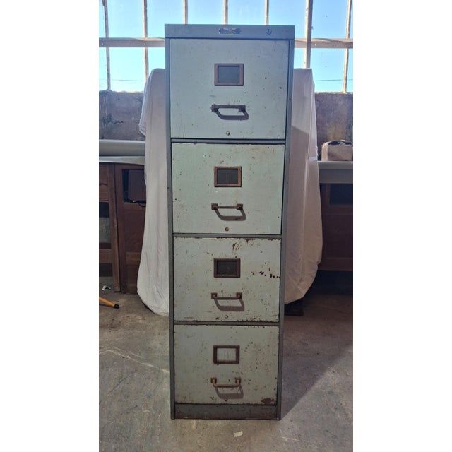 Industrial metal filing cabinet. this vertical, four-drawer filing cabinet is made in france and signed y.a. Chauvin, a...