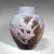 This is a vintage decorative flower vase. An English, ceramic baluster urn hand-painted by James Skerrett, dating to the...