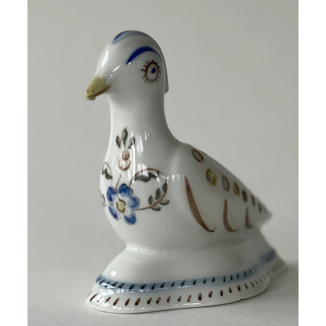 Portuguese faience ceramic bird with hand-painted folk details and old-world appeal. This sweet hand-painted ceramic bird...