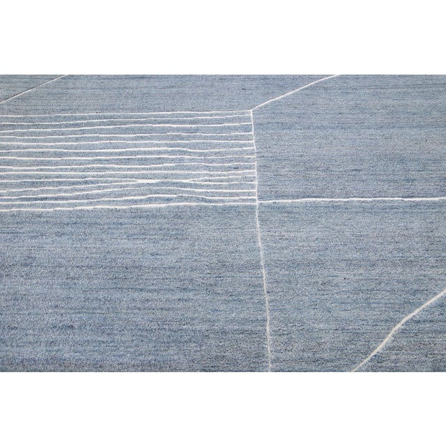 Beautiful modern Moroccan-style hand-knotted wool rug with a light blue color field. This rug is part of our Apadana's...