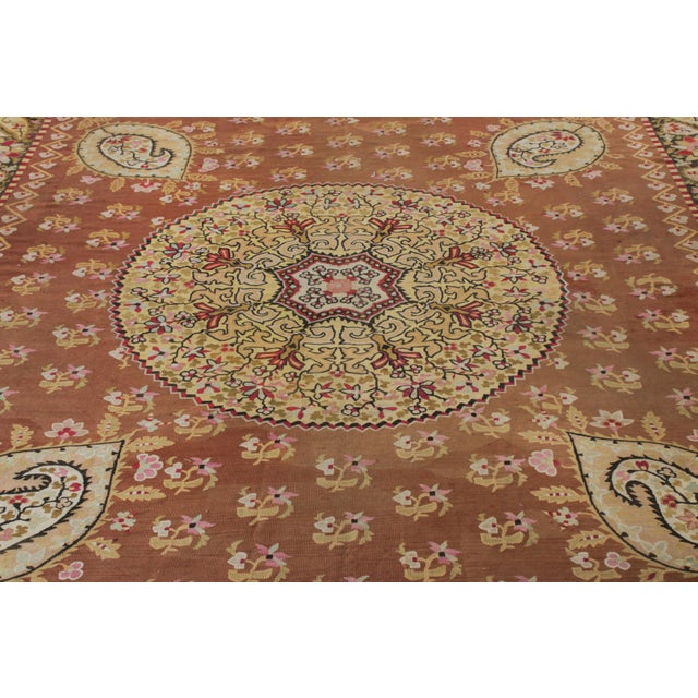 Handwoven in wool from France circa 1880-1890, a 12x13 antique square Aubusson flatweave making way to Rug & Kilim’s...