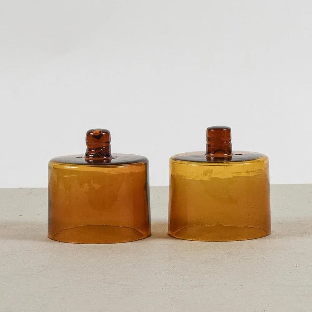This pair of amber glass cloche hoods embodies the charm of the clean, essential lines of art deco, with a simple and...