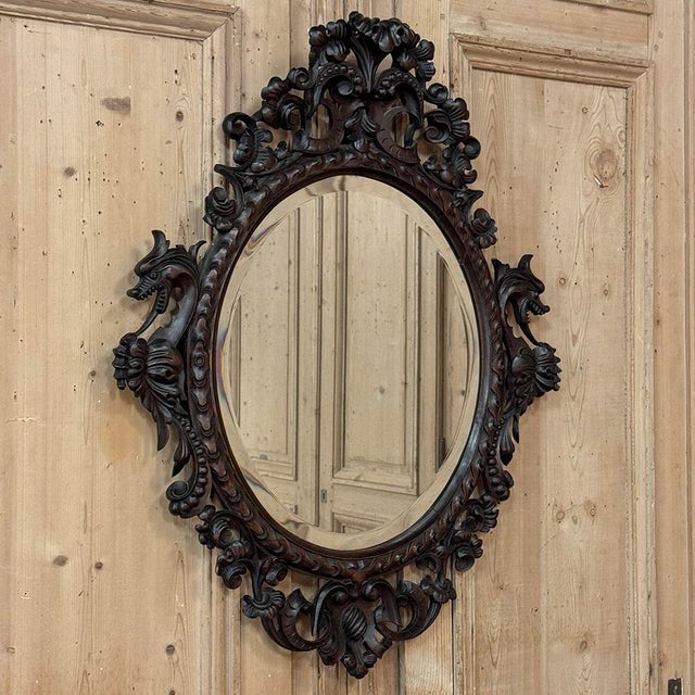 A richly detailed Renaissance Revival mirror dating from the late 19th century into the early 20th century, reflecting the...