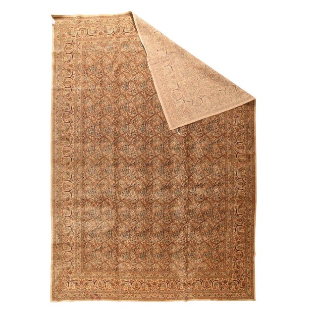 This NW Persian city carpet features a sandy beige field with undulating, serpentine vines forming irregular reserves...