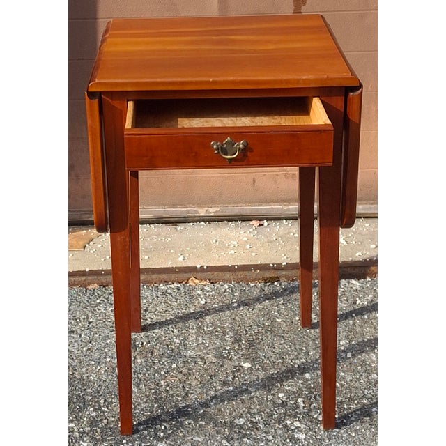 American Federal Style Solid Cherry Single Drawer Drop-Leaf Side Table. Measures 36.5" in width with leaves open, 17" in...