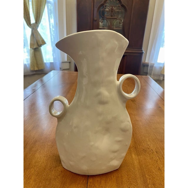 A striking modern organic ceramic sculptural vase/pitcher by Montes Doggett, handcrafted by skilled artisan potters in...