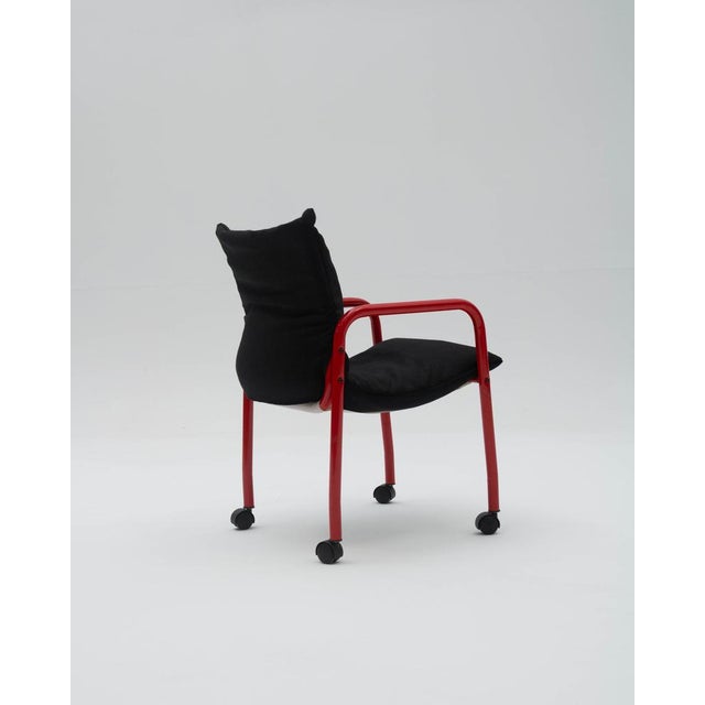 An industrial armchair with a postmodern aesthetic, strongly influenced by the avant-garde design of the 1980s, where bold...