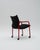 An industrial armchair with a postmodern aesthetic, strongly influenced by the avant-garde design of the 1980s, where bold...