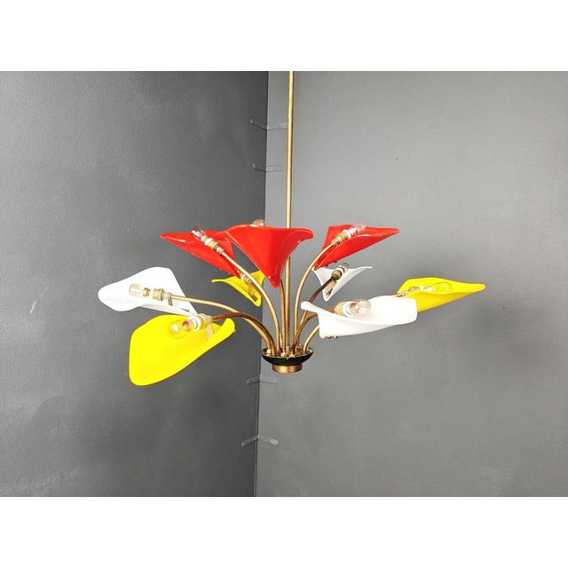 Gorgeous mid century italian chandelier with multicolour acrylic glass lamp shades and a patinated brass frame. Beautiful...