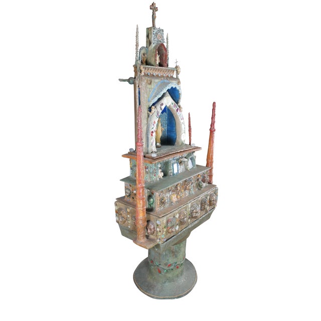 Multi-tiered assemblage art shrine or altar. It incorporates a wide variety of religious and symbolic elements,...